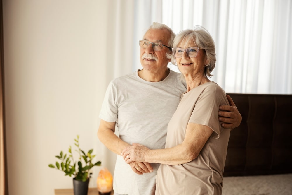 Older couple embracing at home