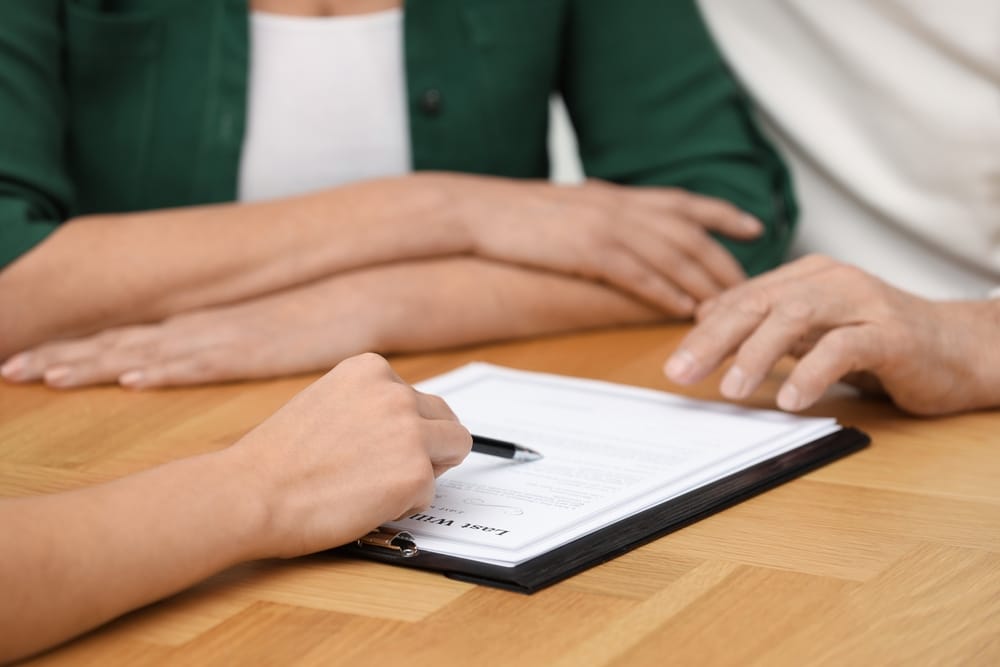 Signing a legal document at a table